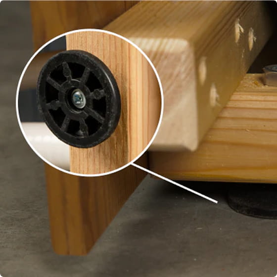 Close-up of Premium Sand filter leg with a black wheel and screw, on a dark surface.