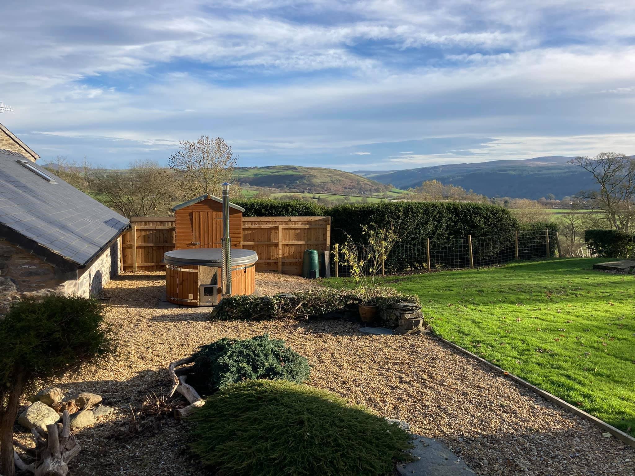 Gardenvity hot tub with scenic hills in the background – authentic customer photo.