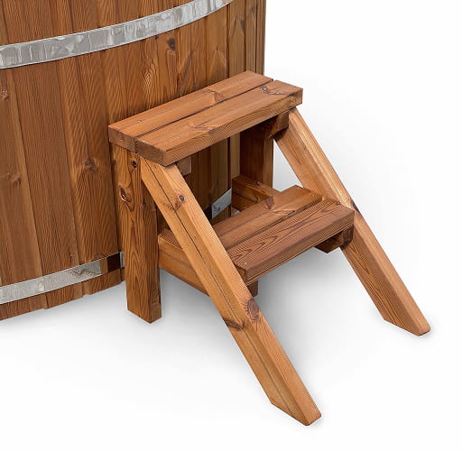Standard wooden steps ladder against a wooden hot tub's wall on a white background